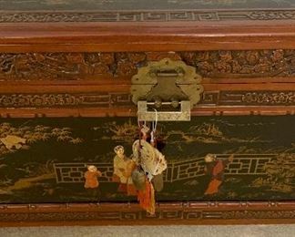 Chinese Lift Top chest, carved and decorated lacquer decoration on top and sides of scholars in a garden.  Camphorwood and cedar.  Measures 40x21x20