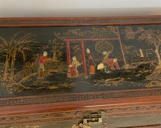 Chinese Lift Top chest, carved and decorated lacquer decoration on top and sides of scholars in a garden.  Camphorwood and cedar.  Measures 40x21x20