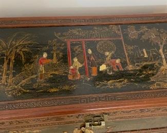 Chinese Lift Top chest, carved and decorated lacquer decoration on top and sides of scholars in a garden.  Camphorwood and cedar.  Measures 40x21x20