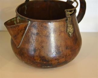 copper pot with blue and white ceramic handle