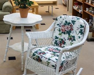 Wicker rocker and distressed vintage table.