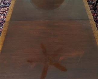 Top of the Baker "Historic Charleston Reproductions" banded mahogany dining table.