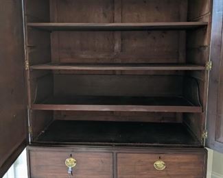 Interior of the antique English mahogany linen press; original brass pulls.