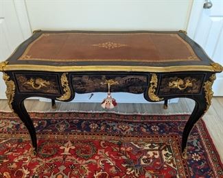 Spectacular French hand-painted Chinoiserie desk, with gilt bronze mounts and tooled leather top. There are three functional drawers on the front of the desk and the opposite side is a mirror of the front, but w/o functional drawers.