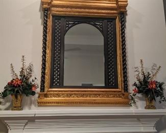 Large black/gilt wood wall mirror (measures 5' T x 4' W) flanked by an attractive pair of silk floral arrangements, in toile planters.
