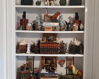 One of two bookcases flanking the fireplace, featuring vintage books, cast iron collection, Asian porcelains and an entire village of Hummel figurines.