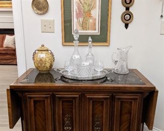 Vintage 1970's marble-topped, drop-leaf server, by Unique Furniture Co., Raritan, NJ., silverplated serving tray, with crystal decanters and brandy snifters and ABCG pitcher.