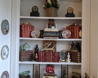 The other bookcase, flanking the fireplace, with more vintage books, porcelain plates, figurines and cast iron collection.