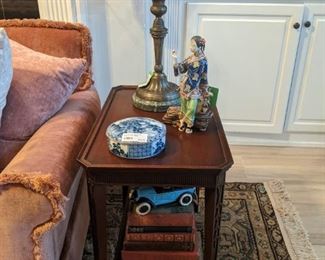 One of a pair of 1940's mahogany side tables, with vintage brass/marble table lamps, with rose glass shades, Tiffany blue/white porcelain box, stack of antique books and an amazingly detailed, artist-signed Asian porcelain figurine - there's a pair of them.