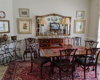 Large, airy dining room, with Baker Furniture "Historic Charleston Reproductions" double pedestal banded mahogany dining table, with three leaves, each measuring 18" wide; without leaves, the table measures 46" W x 70" D x 34"H.                                                                                                              Set/8 (2 armchairs, 6 side chairs)  hand-carved mahogany ball and claw dining chairs.                                                          Matching Baker "Historic Charleston Reproductions" banded mahogany sideboard (67.5ʺ W × 26ʺ D × 38.5ʺ H). Bronzed brass tea cart, from Barcelona gorgeous pair of Irish crystal table lamps, large wall mirror, measuring 44" T x 74" L.