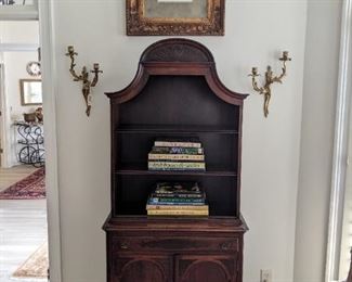Vintage 1940's mahogany lighted (three levels) curio cabinet, with single drawer, double doors, vintage pair of brass 2-light wall sconces, nicely framed/matted bird print and collection of good coffee table books.