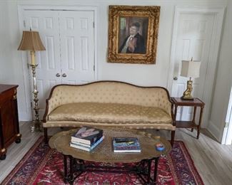 Vintage buttah yellow silk upholstered sofa (goose down 75%, goose feathers 25%) by Cocheo Brothers, retailed by Ray Lang (Atlanta), flanked by a marble-topped mahogany end table, gold metal lion lamp atop, silverplated floor lamp, large, scalloped edge brass/mahogany coffee table, with stretchers and original oil of lovely man, in gold frame - artist signed.