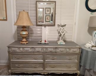 Vintage French Provincial 7-drawer dresser, freshened with silver leaf paint, resin garden fairy and silver wood beveled glass wall mirror.