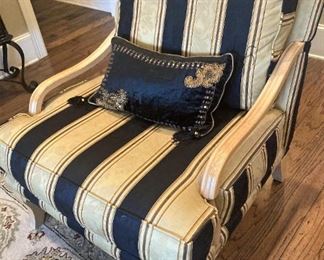 One of two gold and black arm chairs