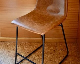 One of a pair of leather and metal counter stools by Dorel furniture.
