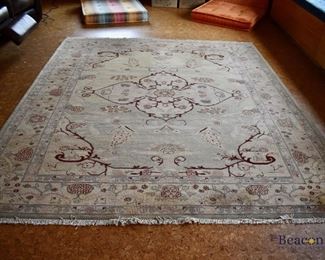 Handknotted beige rug with red accents. Approx. 8'4” x 9'10”