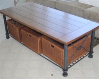 Metal and wood coffee table with basket storage.