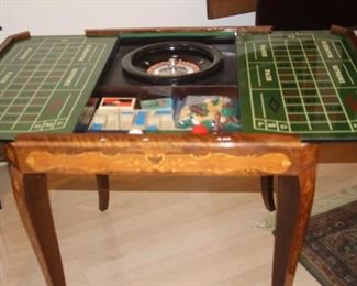 Italian games table with removable top to show under side with back gammon, chess, mah jong, and roulette.
