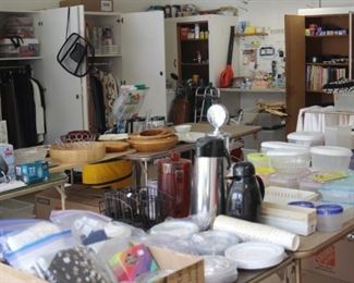 Garage full of tables and cabinets of all kinds of things.