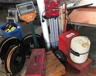 lower left are the 3 commercial water hose reels w/ the yellow hoses, Garden Way electric sprayer on the right, Toro grass blower on top, Digi-Star scale in the middle