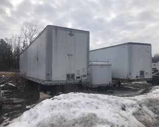 2 - semi truck trailers, one is a Dorcey and the other is a Strick. "front view"