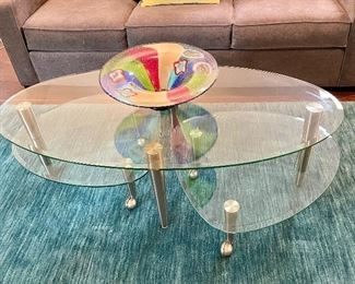 $300 Contemporary two tiered coffee table with chrome legs. Lower shelves rotate outward for additional surface space. 55w 17h 27d