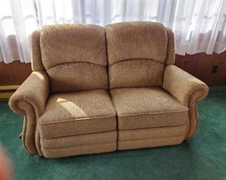 This love seat and the matching sofa are recliners