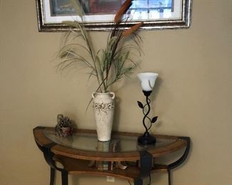 Half round console table with several décor items