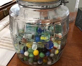 Great selection of old marbles in a pickle jar.