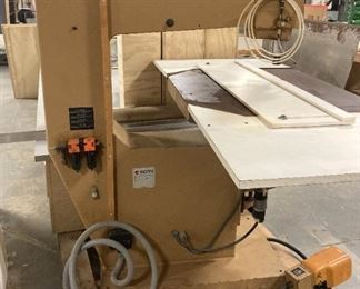 THE BASE OF THE ROUTER, SHOWING POWER CABLE, FOOT CONTROL PEDAL, AND THE PALLET.