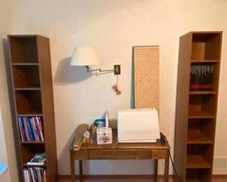 Sewing Machine
2 tall and skinny book shelves including sewing books, a sewing table with an electric ELNA sewing machine, some sewing notions, quilting board, sleeve board and wall light
