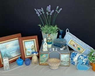 Blue Household Decorations
Faux plants in wood planters (3), baskets, blue glass candy dish with lid, porcelain owls with books (3), original paintings of the seaside in frames, two small seagull wall hangings lacquered to wood, other Knick knacks.
