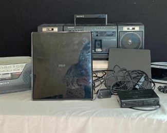 Small Electric Entertainment
Sony boom box with cassette players, Sony CD player boom box, alarm clocks (2), RCA TV antennas (2) - big flat one is co-ax only, small with digital box is also HDMI.