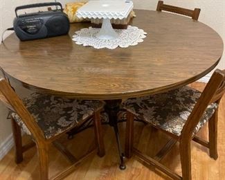 Round kitchen table with metal base and 6 chairs