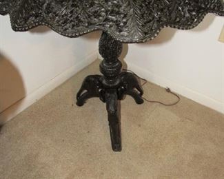 Heavily carved antique table with elephant feet