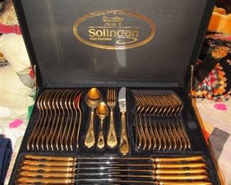 Never used complete set of gold plated Solingen flatware with serving pieces