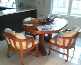 Oak pedestal  table with chairs on wheels 