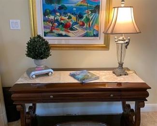 Entryway table with various decorative pieces.