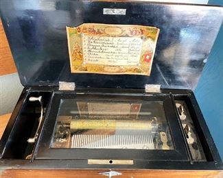 Antique mechanical music box plays all songs listed