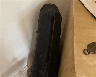 Wooden violin case for the violin that’s framed.