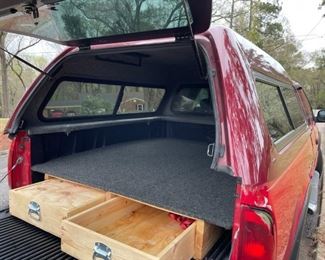 Carpeted Mid-rise camper for 6.5 ft bed truck. Sliding glass window with screens with a removable window to cab. Also has a 2 drawer pullout system for the truck bed.