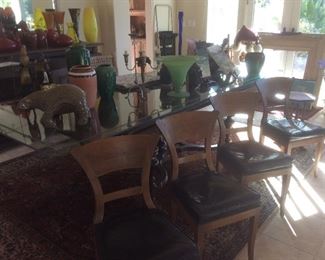 Four vintage dining chairs with black vinyl