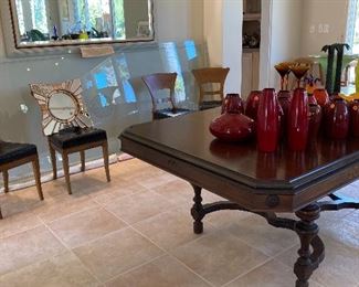 Dining table with out glass piece, glass is against wall, large mirror
