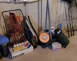 Bocce ball set, volleyball,  boots and bindings, tennis racquets, paddle ball
