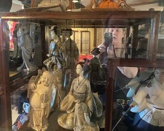 Curio packed with asian figurines and art pieces
