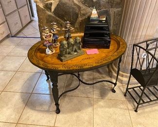 Oval table with wrought iron base