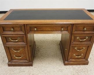 1025	OAK 7 DRAWER DESK W/LEATHER TOP, APPROXIMATELY 50 IN WIDE X 23 IN DEEP X 30 IN HIGH
