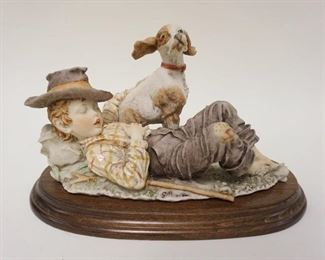 1065	G ARMANI FIGURE OF YOUNG BOY SLEEPING W/HIS DOG, APPROXIMATELY 12 IN LONG X 8 IN HIGH
