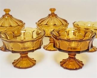 1081	5 FOSTORIA AMBER COIN GLASS COMPOTES, TWO HAVE LIDS. APP. 10 IN H INCLUDING LID
