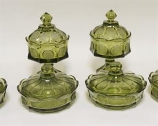 1082	8 PIECES OF OLIVE GREEN FOSTORIA COIN GLASS. LOT INCLUDES FOUR WEDDING BOWLS & FOUR LOW  COVERED CANDY DISHES. WEDDING BOWLS APP. 9 1/4 IN H 
